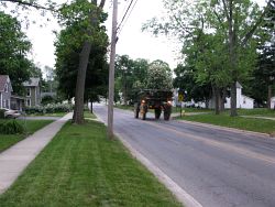 2009_05_26 Mason Michigan interesting farming vehicle zooming down Maple Street