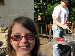 2009_05_29 Mason Michigan My granddaughter Hazel with her father cooking dinner